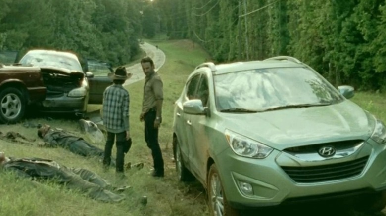 Carl and Rick Grimes by roadside