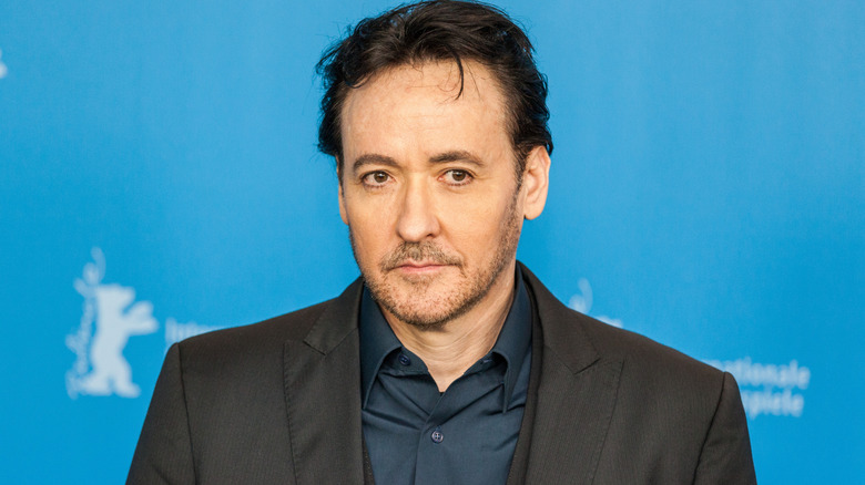 John Cusack posing for photographers at the Berlin International Film Festival in 2016