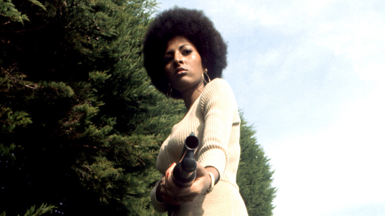 Coffy points a gun at the camera in Coffy (1973)