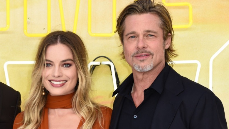 Margot Robbie and Brad Pitt posing