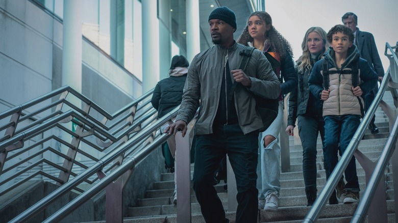 Emily, Matt, Alice, and Leo walking down outdoor stairs