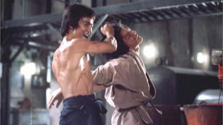 Bruce Lee grabs a henchman by the hair