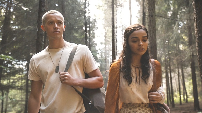 Lucy and Snow walking through the woods