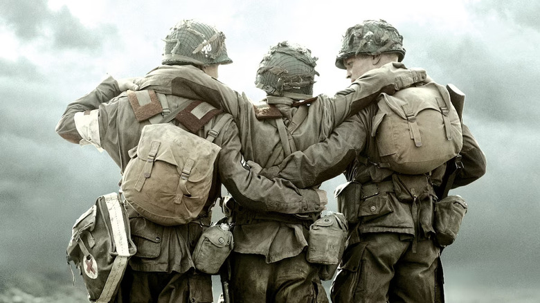 Two soldiers carry a hurt comarade