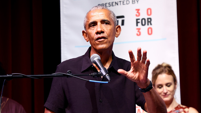 President Obama speaking with hand up