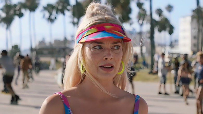 Barbie in neon visor looking confused