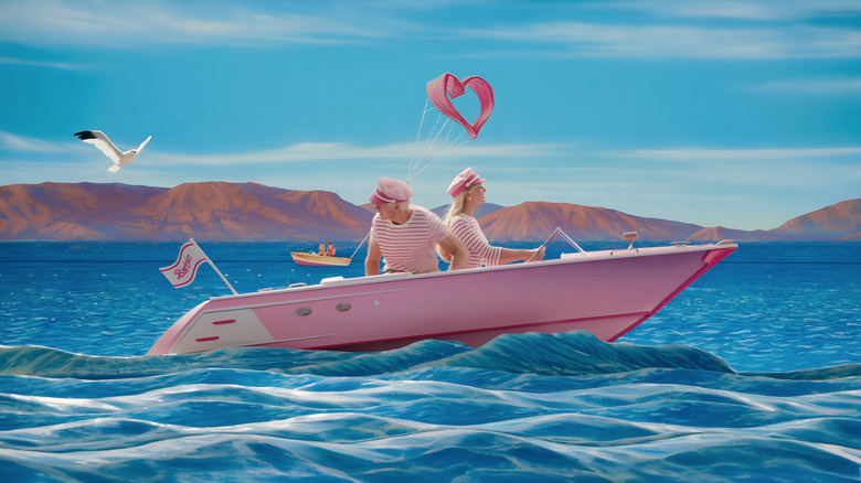 Ken and Barbie driving a pink boat