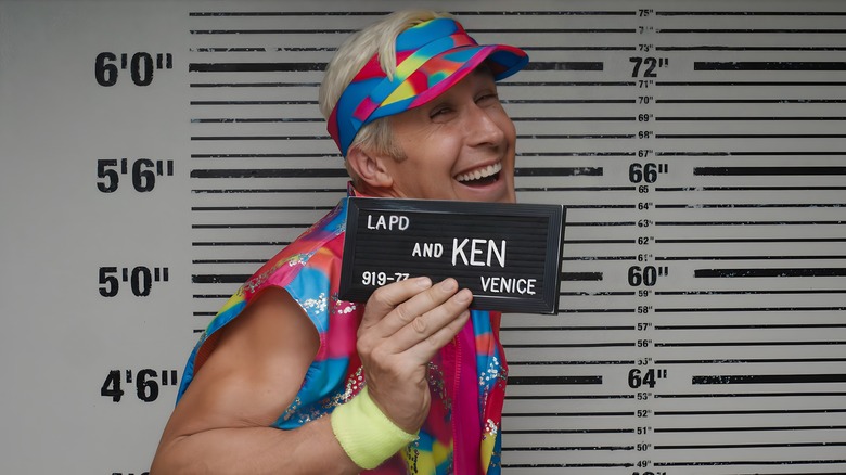 Ken holding card mugshot