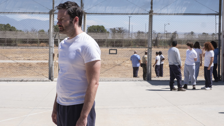 Barry standing in an outdoor prison yard