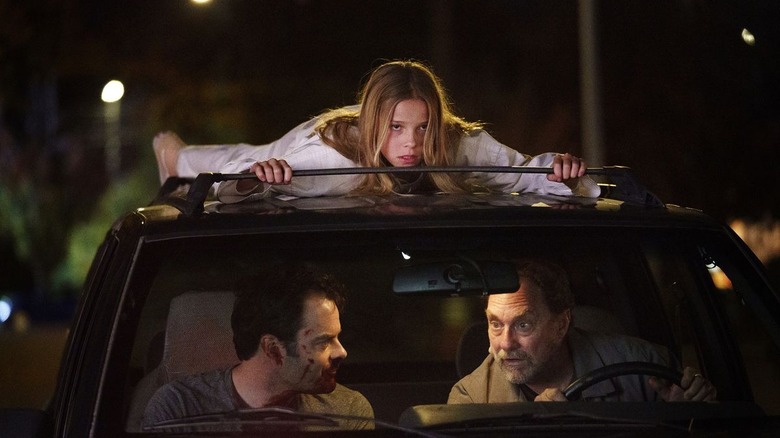 Lily riding atop a car