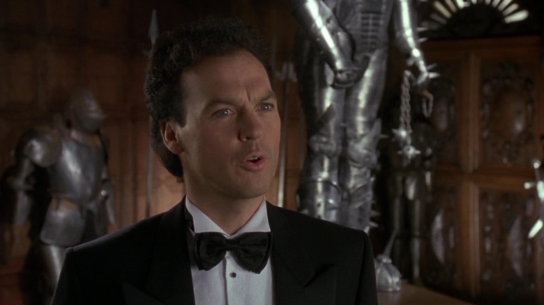 Michael Keaton smirking as Bruce Wayne