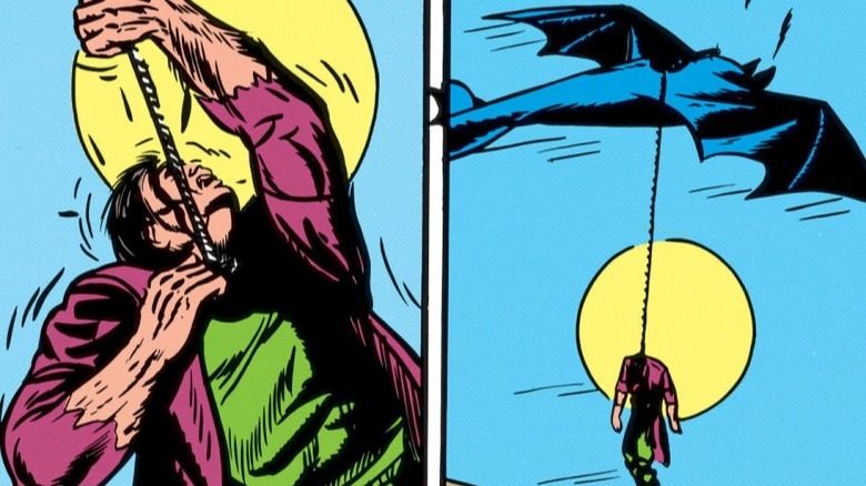 Batman hanging a Monster Man from the Batplane