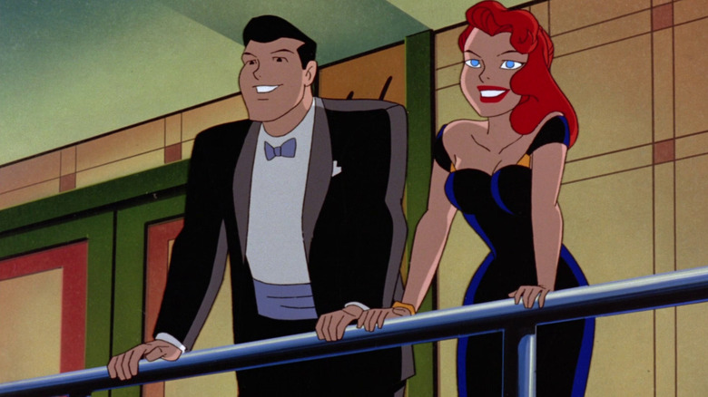 Dick Grayson and Barbara Gordon smile while holding a rail