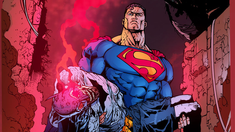 Superman holding Batman's corpse