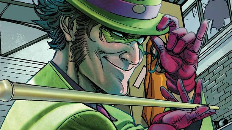 Riddler holds cane and winks