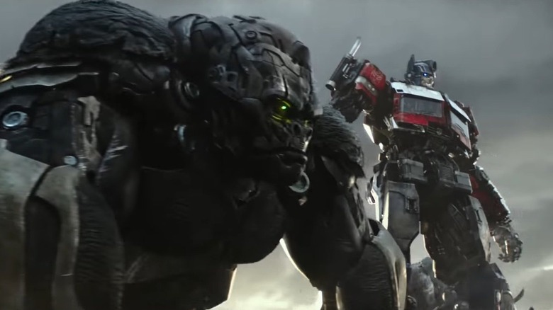 Optimus Primal standing with Optimus Prime