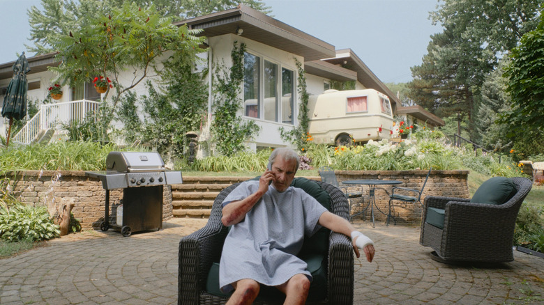 Beau siting in a chair on the phone 