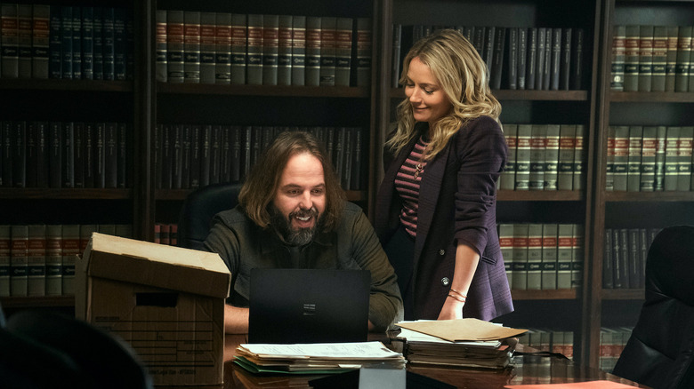 Lorna with fiancee Cisco in front of bookshelves