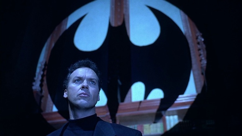 Bruce Wayne in front of Bat-Signal