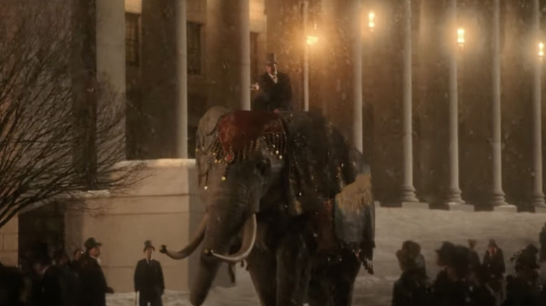 P.T. Barnum rides an elephant through the street