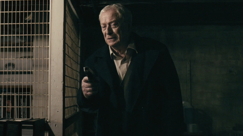 Harry Brown holding gun