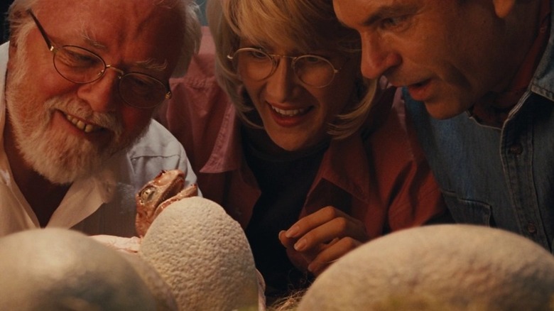 Scientists looking at dinosaur eggs