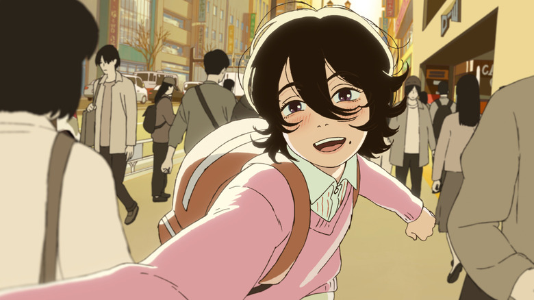 Kyomoto runs down a crowded sidewalk in "Look Back" (2024)