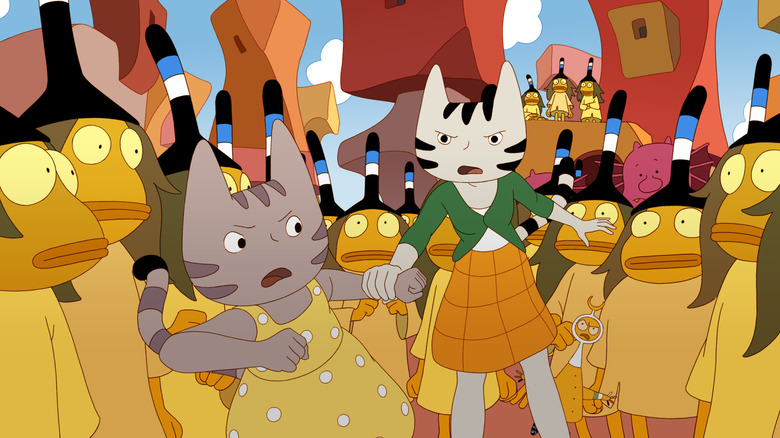 Carmen and Juliette are surrounded by frog-like creatures in "Sirocco and the Kingdom of the Winds" (2023)