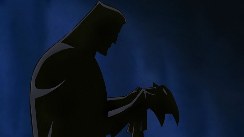 Bruce Wayne silhouetted with mask