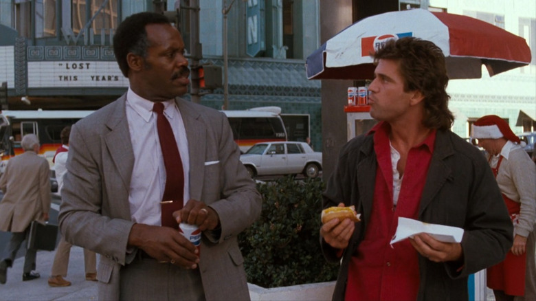 Danny Glover and Mel Gibson talking