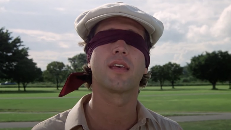 Chevy Chase wearing blindfold