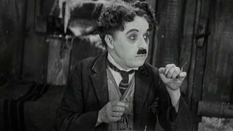 Charlie Chaplin eating shoe