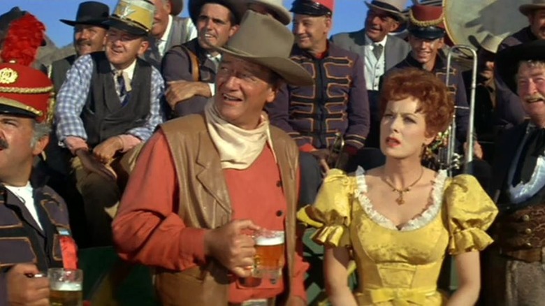 John Wayne and Maureen O'Hara in crowd