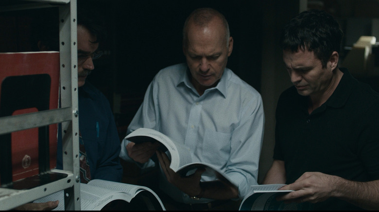 Spotlight journalists examining books