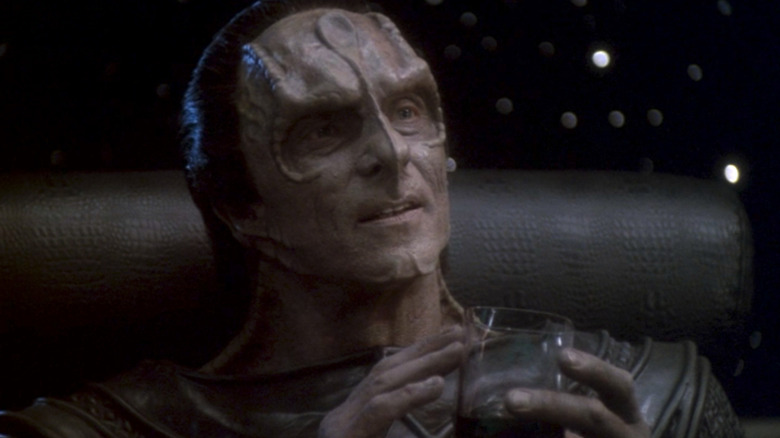 Dukat holds a glass