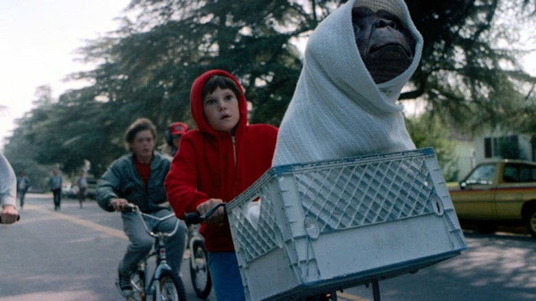 Elliott riding bike with ET in basket