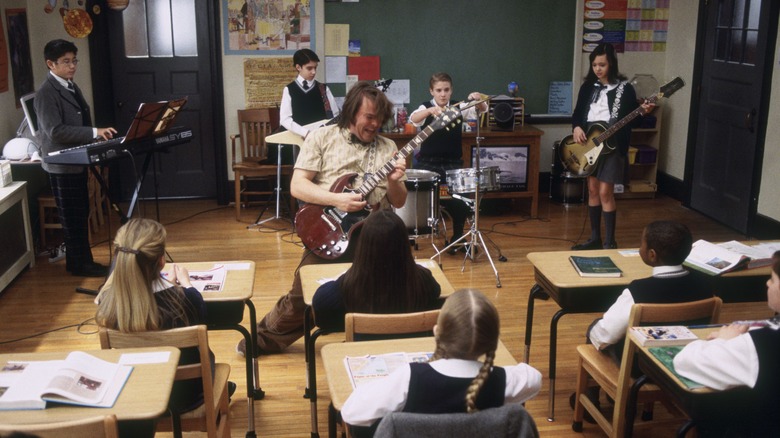 Dewey playing guitar in class