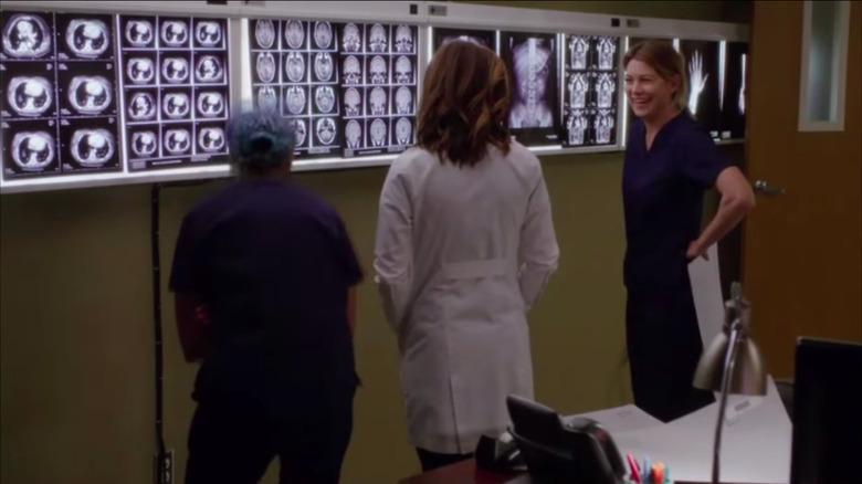 Meredith standing in front of x-rays