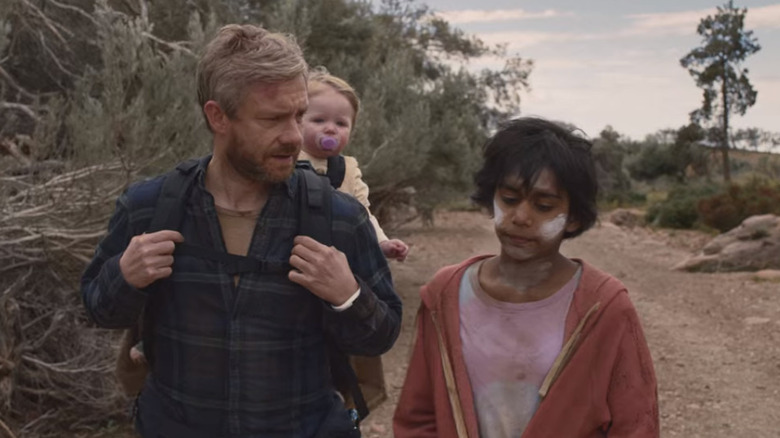 Martin Freeman and child walking