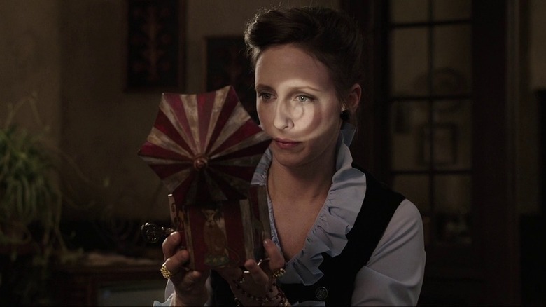 Vera Farmiga looking in a box