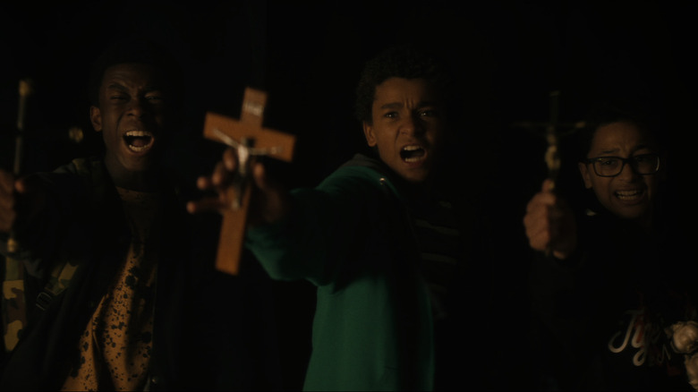 Boys holding out crosses