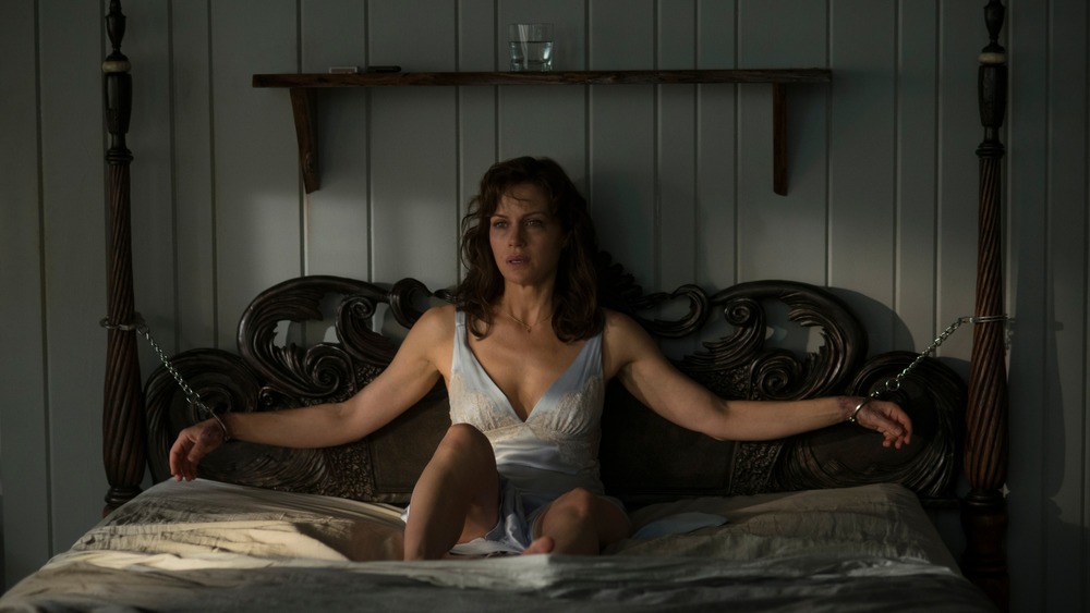 Carla Gugino handcuffed to a bed in a scene from Gerald's Game 