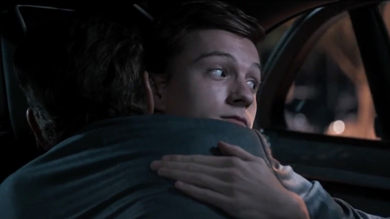 Peter Parker hugs Tony Stark