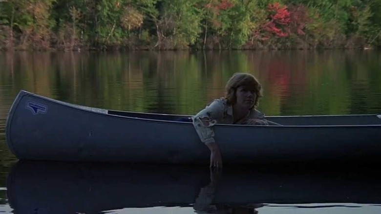 Alice floats in a canoe on an eerily still lake in Friday the 13th