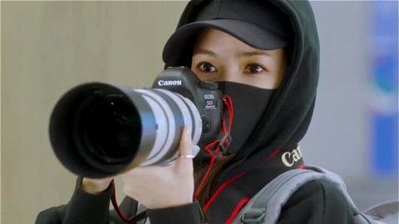 Min-young holding a big camera