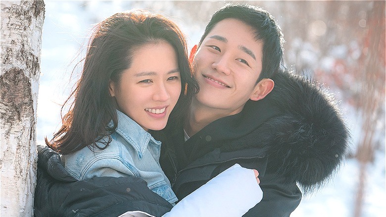 Jin-ah and Joon-hee embracing outdoors