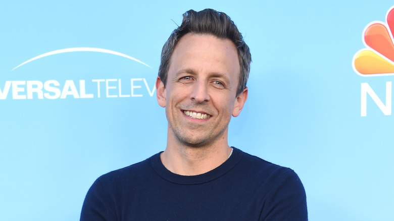 Seth Meyers against blue background