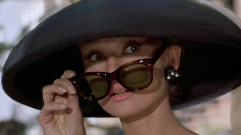 Holly Golightly lowers sunglasses