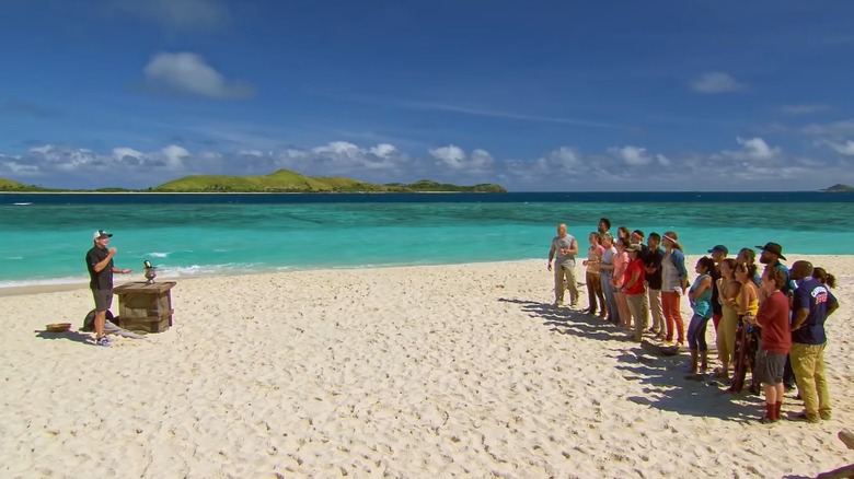 Survivor castaways around a fire