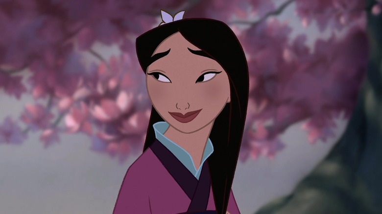 Mulan smiling beneath tree